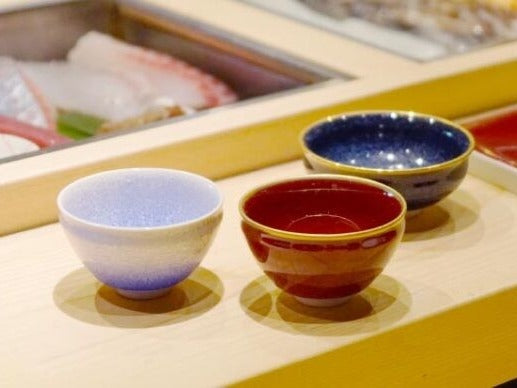 Three Shinemon Kiln sake cups in Ginga galaxy blue, Shinsha cinnabar red and pale blue glaze, Arita ware